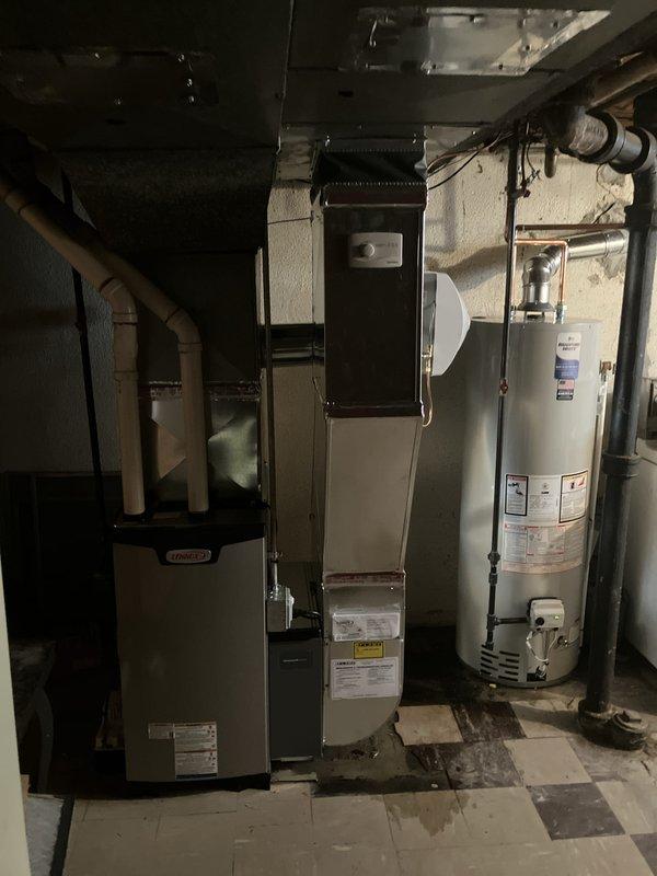 Completed full HVAC system installation including new Lennox furnace unit and 40-gallon water heater in basement utility area. Installed new Honeywell programmable thermostat with digital display and connected to heating system. Configured ductwork connections and integrated condensate pump into system. Coordinated utility rebate application and obtained necessary permits for installation. All equipment tested and operational upon completion.