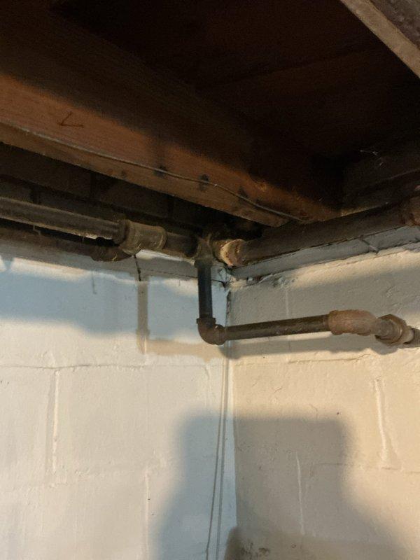 Responded to emergency gas leak call where utility company had shut off and tagged gas supply to multiple appliances. Upon arrival, inspected furnace, water heater, and three additional locations previously identified by utility company. Conducted thorough visual inspection of all gas piping, connections, and joints throughout basement utility area. Examined aging copper and brass gas lines showing significant corrosion and patina, particularly at junction points and bends along foundation walls. Documented all tagged locations and deteriorated piping conditions with photographic evidence. Assessed pipe integrity and identified multiple areas requiring immediate attention before gas service restoration. Provided detailed findings and recommendations for necessary repairs to bring system into compliance with current safety codes and utility company requirements for reconnection.