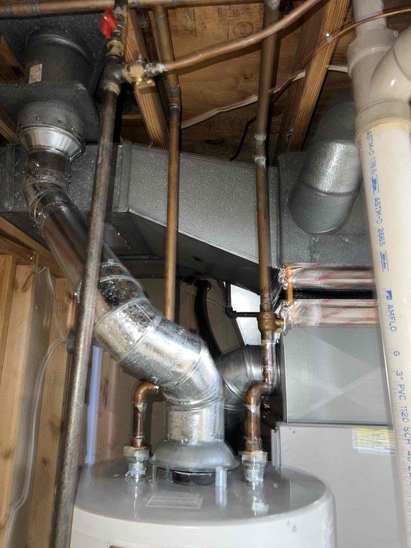 Completed Gold-level furnace inspection on 10+ year old forced air system located in basement. Performed comprehensive combustion analysis using Bacharach analyzer, confirming proper operation with CO2 reading of 7.3%, stack temperature of 97°F, ambient air temperature of 62.4°F, excess air at 55.6%, and CO reading of 53 ppm—all within acceptable parameters. Inspected horizontal air handler unit, associated ductwork, and plumbing connections, documenting equipment condition with photos for service records.