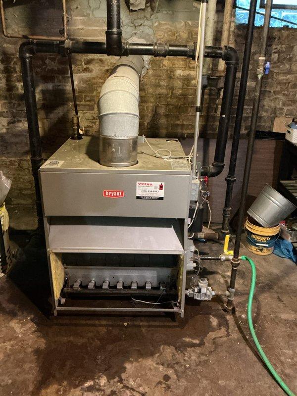 Conducted comprehensive assessment of non-operational 10+ year old natural gas steam boiler system serving radiator-based heating. Evaluated existing Bryant boiler installation, associated piping infrastructure, and distribution system components. Documentation revealed significant equipment age, deteriorated basement conditions with moisture-damaged masonry walls, aged copper piping with oxidation, and compromised venting systems. Confirmed all radiators operational without leaks, but primary unit failure necessitated replacement recommendation due to equipment age and reliability concerns. Provided detailed photographic documentation of existing steam boiler configuration, gas piping, condensate returns, and overall system layout for replacement planning purposes.