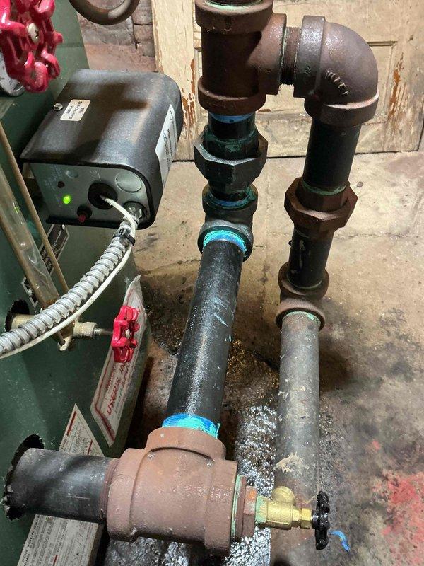 Completed boiler piping repairs by removing and replacing corroded 2" steel components. Removed deteriorated 2" nipple, 2" 90-degree elbow, and 2" union that showed significant rust and mineral buildup. Installed new 2" steel nipple, 90-degree elbow, and union to restore proper system integrity and ensure reliable boiler operation.