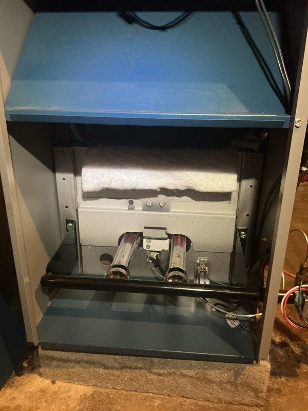 Completed comprehensive Gold Boiler Inspection on 18-year-old hot water boiler and furnace system located in basement of multi-unit property. Verified both units are operational with furnace burners displaying proper blue flame combustion pattern, indicating correct air-fuel mixture and efficient gas burning. Inspected internal components including blower motor assembly, heat exchanger, burner assembly, electrical connections, and control systems. Examined PVC venting and condensate drainage system for proper configuration and clearances. Assessed boiler cabinet interior components including dual burner assemblies, control panel functionality, and insulation integrity. All safety controls, wiring harnesses, and mechanical assemblies found to be in functional condition with no immediate safety concerns identified during inspection.