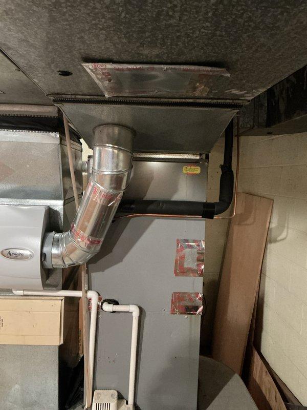 Completed furnace inspection and equipment assessment for forced air heating system located in basement. System is currently operational with equipment age exceeding 10 years. Evaluated existing furnace unit with Aprilaire humidification component, assessed ductwork configuration including main plenum and flexible duct connections, and documented overall system condition to provide replacement estimate recommendations for aging HVAC equipment.