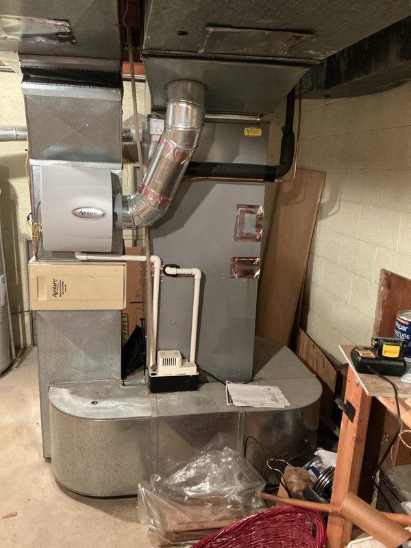 Completed furnace inspection and equipment assessment for forced air heating system located in basement. System is currently operational with equipment age exceeding 10 years. Evaluated existing furnace unit with Aprilaire humidification component, assessed ductwork configuration including main plenum and flexible duct connections, and documented overall system condition to provide replacement estimate recommendations for aging HVAC equipment.