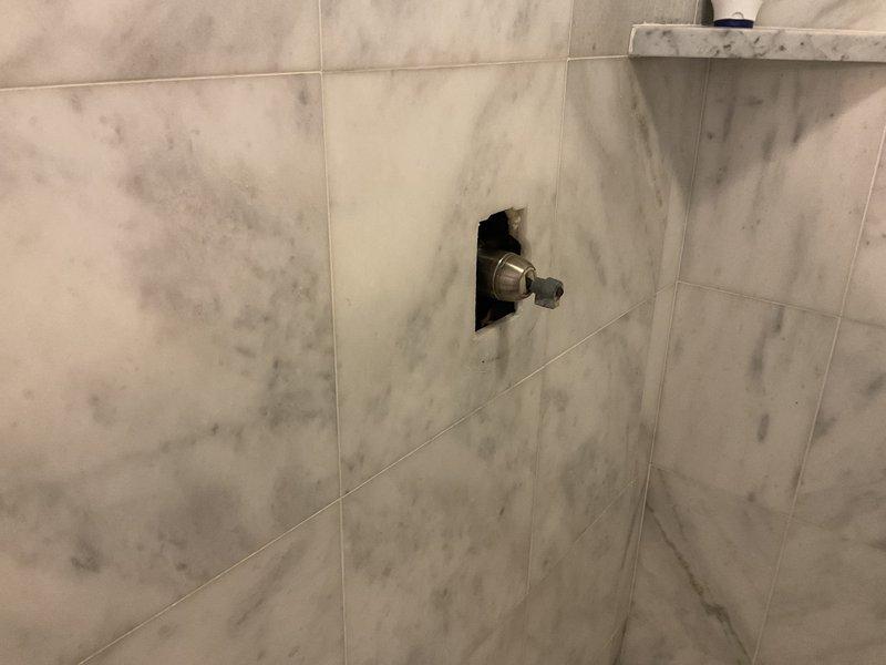 Responded to bathroom faucet leak complaint in bathroom adjacent to kitchen. Upon arrival, inspected all bathroom fixtures including shower valve control, tub spout, and associated plumbing connections. Identified source of leak and performed necessary repairs to eliminate water seepage. Tested all fixtures for proper operation and confirmed no additional leaks present. Work completed successfully with all fixtures functioning properly.