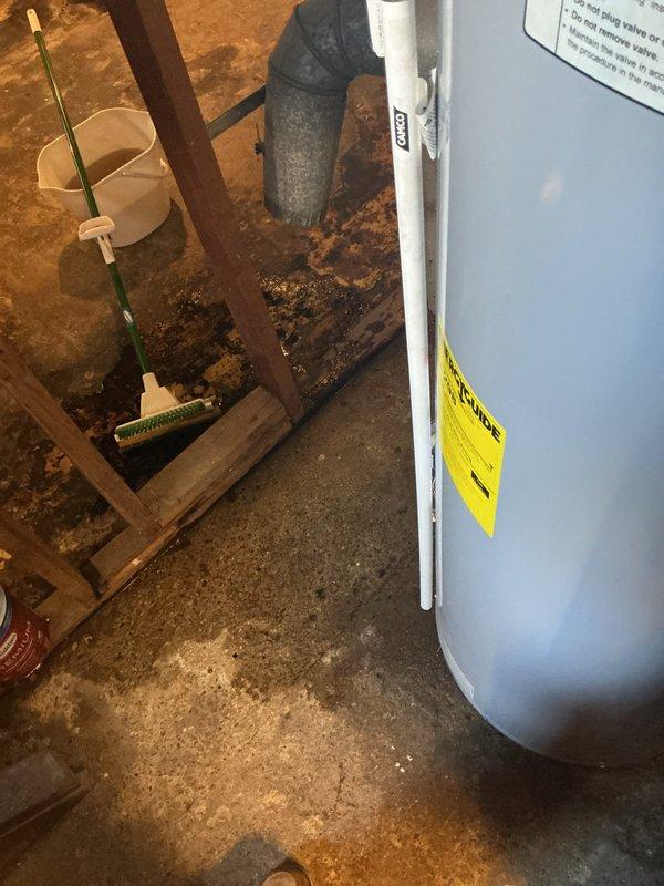 Responded to warranty call for leaking tanked water heater manufactured by Flame with active 10-year manufacturer and labor warranty coverage. Upon inspection, confirmed water heater was actively leaking from bottom of tank due to severe corrosion and rust deterioration of tank base and drain valve assembly. Documented extensive oxidation damage with photographic evidence showing compromised structural integrity of metal components and water damage on basement floor. Assessed unit as failed beyond repair due to tank breach, requiring full replacement under warranty terms.