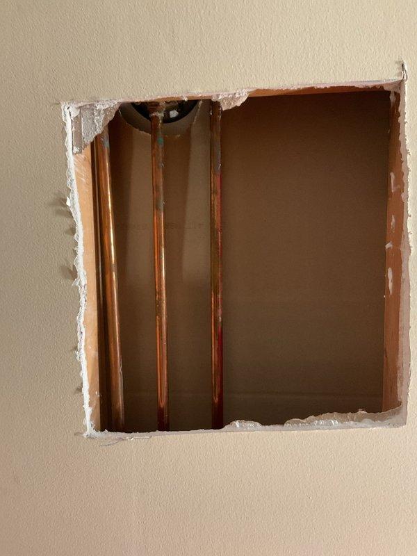 Installed two shut-off valves on the shower supply lines in the main second-floor bathroom. Cut access openings in the wall to expose the copper water supply pipes, installed isolation valves on each feed line to allow independent shut-off capability for future maintenance or repairs.