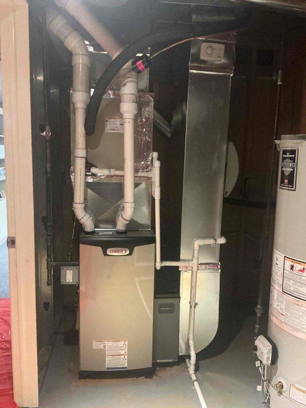 Completed installation of 70,000 BTU Lennox furnace system in residential basement mechanical room with proper PVC venting configuration for combustion air intake and exhaust. Installed humidifier unit and performed electrical reconnection, ensuring all components properly integrated with existing water heater and HVAC infrastructure. Mechanical and electrical permits obtained, system tested and verified operational, with utility rebate documentation submitted.