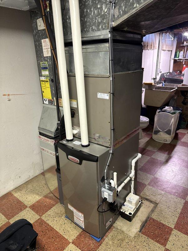Completed installation of 70,000 BTU gas furnace in residential basement location. Installed new white PVC intake and exhaust venting system with proper vertical routing and secure fittings. Configured condensate drainage system with PVC piping and trap assembly to handle moisture removal. Reconnected all electrical connections using flexible metal conduit and verified proper grounding. Installed air handler unit with ductwork connections to existing system. Measured and verified return air configuration for optimal system performance. All components mounted securely to manufacturer specifications with appropriate clearances maintained. System tested and confirmed operational upon completion.