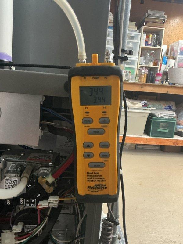 Completed comprehensive tune-up and maintenance on 8-year-old Lennox Elite Series furnace located in basement. Performed full system inspection including combustion analysis, pressure testing with dual port manometer showing proper gas pressure readings at 394, verified all electrical connections and control board operation, inspected heat exchanger for cracks or deterioration, cleaned burner assembly, and tested safety controls. Inspected Healthy Climate HCWB3-12 Compact Bypass Humidifier and replaced humidifier pad as part of seasonal maintenance. All components operating within manufacturer specifications, system tested and confirmed functioning properly for heating season.