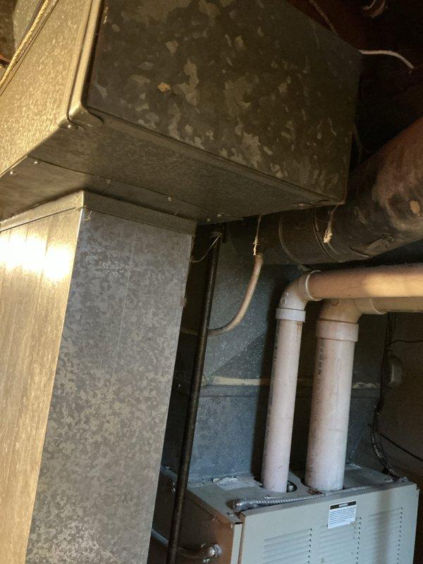 Conducted comprehensive assessment of 20+ year old basement-installed air conditioning and natural gas furnace system for replacement estimate. Evaluated existing HVAC equipment configuration, ductwork infrastructure, utility connections including gas lines and electrical service, and available installation space within basement mechanical area. Documented current system layout, condensate pump operation, copper refrigerant lines, and overall equipment condition to develop accurate replacement specifications for new AC and furnace installation.