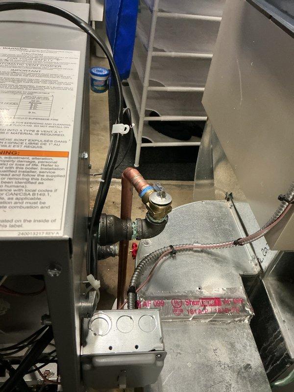 Responded to service call for moisture detected beneath newly installed boiler in basement. Upon inspection, identified minor leak at brass valve fitting on supply line connection. Tightened valve connection and verified all plumbing joints for proper seal. Monitored system during operation cycle with no further moisture detected. Unit returned to normal operation with all connections secure.