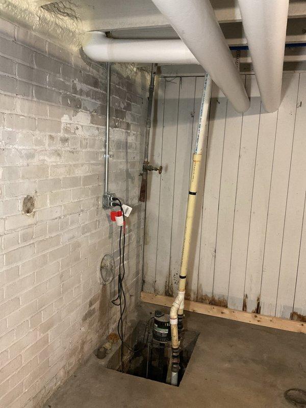 Responded to service call for sump pump system not receiving water due to suspected clogged drainage pipes. Upon inspection of the basement sump pit, assessed the submersible pump unit, PVC discharge piping, and associated drainage infrastructure. Cleared blockage from inlet drainage pipes to restore proper water flow to the sump pump valve, tested system operation to verify pump activation and discharge function, and confirmed all components were functioning correctly.