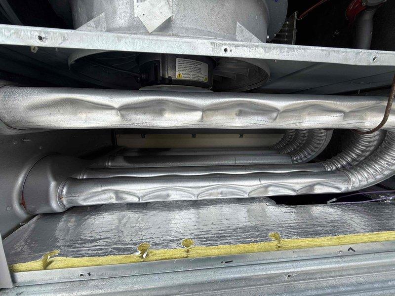 Performed comprehensive commercial HVAC maintenance inspection on six units including four rooftop units and two ceiling-mounted air handlers. Relit pilots on furnace equipment to restore proper heating operation. Accessed rooftop equipment using ladder and inspected ceiling-mounted units from interior locations. Conducted thorough inspection of all air handling components including blower assemblies, flexible ductwork, and galvanized support structures. Inspected and evaluated air filtration systems, verifying proper installation of pleated media filters in ceiling-mounted units. Assessed condition of insulation materials on ductwork and mechanical components. Verified operational status of all heating and cooling systems, confirming equipment functionality following pilot relight procedure. Documented equipment conditions through photographic records showing filter installations, duct configurations, and mechanical assemblies in attic and mechanical spaces.