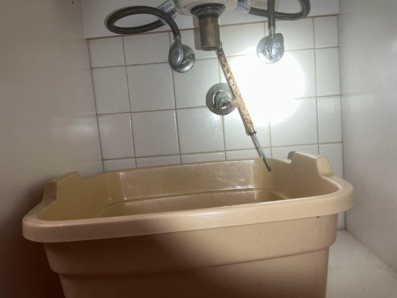 Completed diagnostic evaluation of deteriorated bathroom sink piping with aged, brittle supply lines and wall-mounted connections requiring replacement. Assessed threadless pipe protruding from wall with difficult removal conditions and documented exposed plumbing fixtures showing significant wear and corrosion. Provided on-site estimate for complete pipe replacement work.