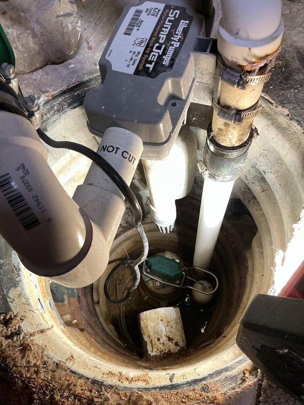 Performed inspection and provided estimate for sump pump replacement in basement. Existing system includes Zoeller M-53 1/3 HP main pump with dual check valves and Liberty water-powered backup pump, originally installed in 2019. Assessed current pump operation, discharge piping configuration, and backup system functionality to determine replacement requirements and specifications.