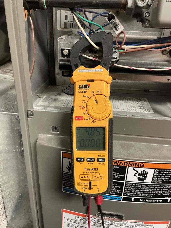 Completed comprehensive Gold Plan furnace inspection on 12-year-old unit in basement. Performed full system diagnostics including electrical measurements using clamp meter, verifying amperage draw at 0.25A and voltage readings of 49.5V at 60Hz on blower motor assembly. Inspected all electrical connections, wiring harness, and motor components for proper operation. Verified all safety labels and warning placards present and legible. System operating within normal parameters with no deficiencies noted. All electrical readings within manufacturer specifications. Unit tested and confirmed operational for continued service.