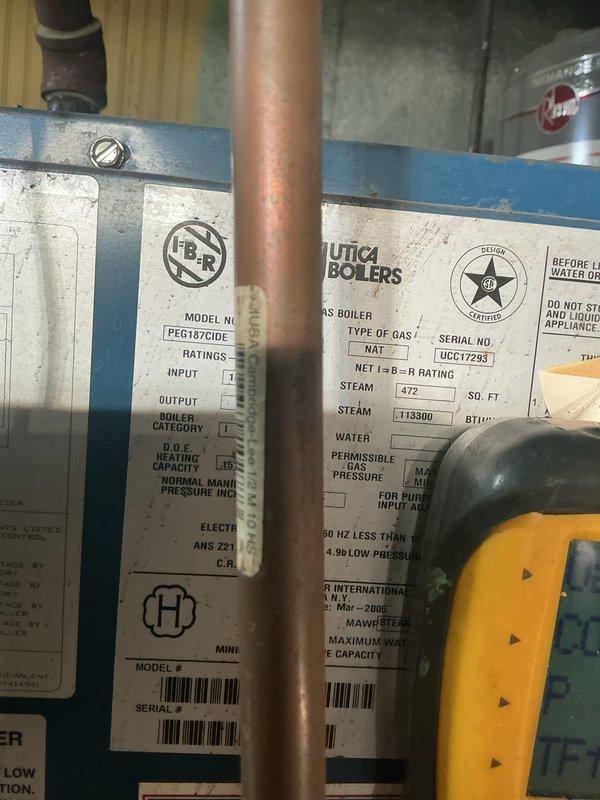 Completed scheduled maintenance on a 34-year-old Utica natural gas boiler system located in basement. Performed comprehensive inspection of boiler components, burner assembly, heat exchanger, and all safety controls. Verified proper operation of gas valve, ignition system, and venting. Inspected copper piping connections and electrical wiring for signs of wear or deterioration. Documented equipment specifications and current operating conditions with photographic records. System operating within normal parameters at time of service completion.