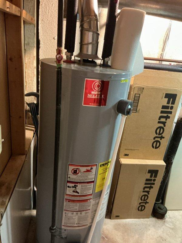 Completed comprehensive Gold-level furnace inspection on an 11-year-old heating unit located in the basement. The system was found to be in proper working order with all components functioning as designed. Inspection included thorough examination of electrical connections, wiring terminals, and control circuits, all of which showed secure connections with appropriate wire nuts and proper color-coded wiring intact. Verified gas connections, heat exchanger integrity, and burner operation. Documented equipment condition with photographic records showing the mechanical room setup, water heater proximity, and internal electrical components for service history records.