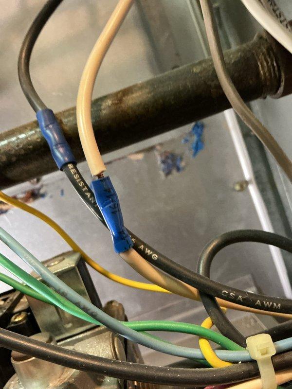 Completed comprehensive Gold-level furnace inspection on an 11-year-old heating unit located in the basement. The system was found to be in proper working order with all components functioning as designed. Inspection included thorough examination of electrical connections, wiring terminals, and control circuits, all of which showed secure connections with appropriate wire nuts and proper color-coded wiring intact. Verified gas connections, heat exchanger integrity, and burner operation. Documented equipment condition with photographic records showing the mechanical room setup, water heater proximity, and internal electrical components for service history records.