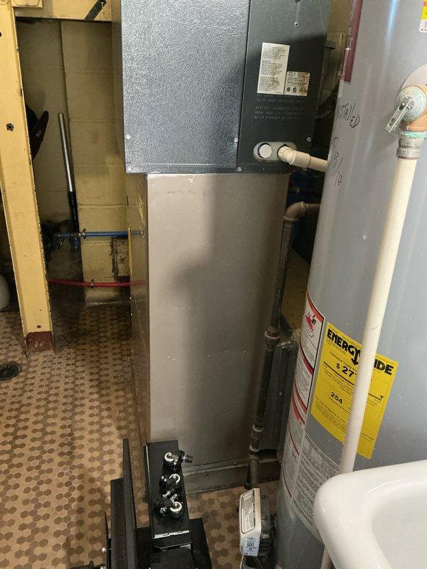 Completed maintenance tune-up on approximately 15-year-old first floor furnace with no reported issues or symptoms. Inspected air handler unit, electrical control panels, and associated mechanical systems in utility room. Documented existing HVAC equipment configuration including water heater connections, PVC drainage lines, electrical components, and control panels to provide comprehensive system assessment for future replacement considerations.