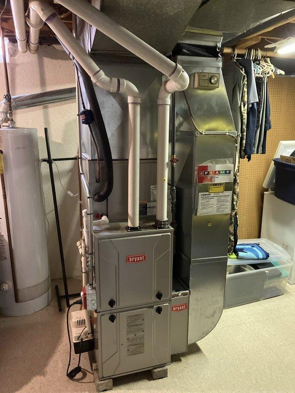 Provided replacement estimate for non-operational natural gas furnace located in basement mechanical room. Evaluated existing Bryant furnace system, associated ductwork, PVC venting configuration, and White-Rodgers thermostat to determine equipment specifications and installation requirements for complete system replacement.