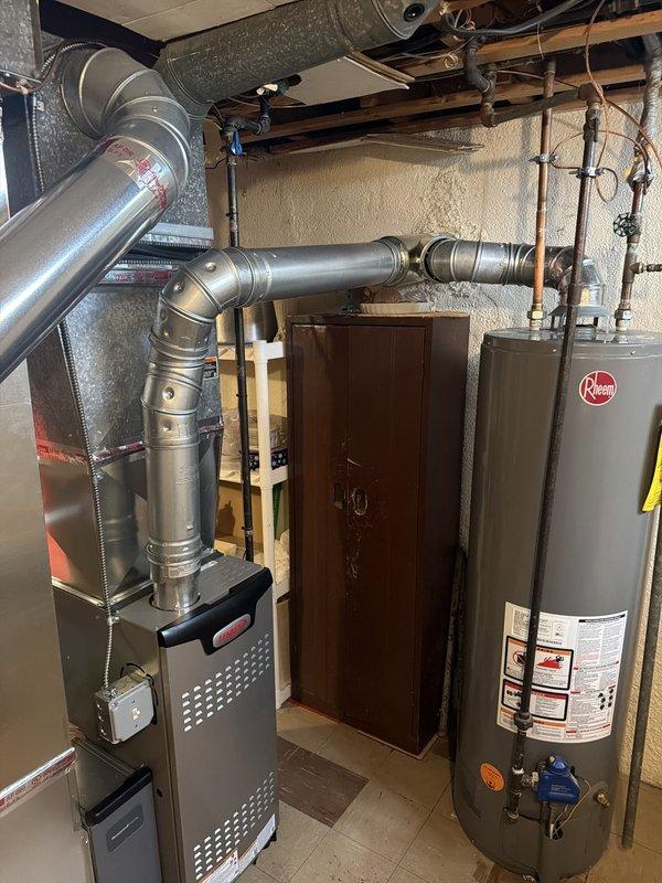 Completed installation of 70,000 BTU gas furnace with new thermostat and humidifier replacement in basement utility area. Obtained mechanical and electrical permits prior to installation, connected all ductwork including flexible and rigid metal piping, and verified proper wiring and electrical connections. Unit installed on protective equipment pads with all components functioning per manufacturer specifications.