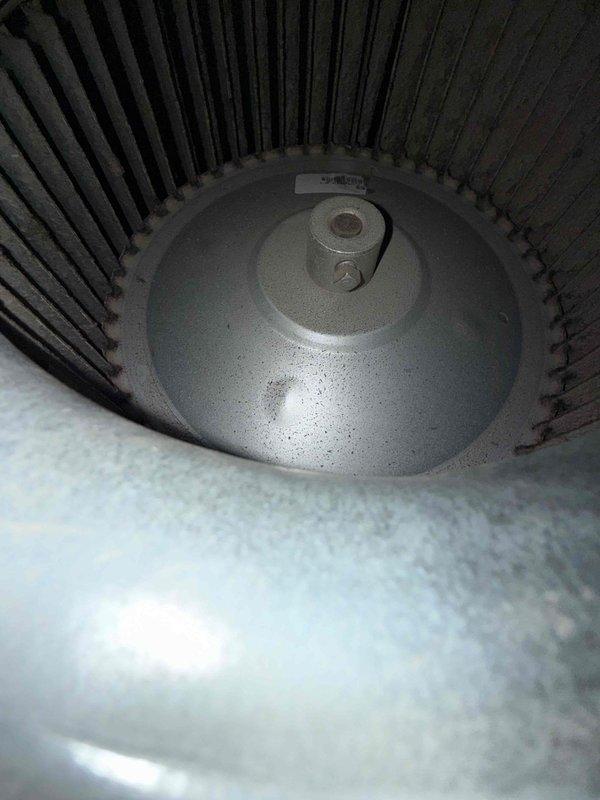 Responded to service call for furnace tripping breaker immediately upon startup with no operation. Unit located in kitchen closet, older model with unknown age. Upon arrival, accessed furnace behind louvered ventilation door and performed visual inspection of internal components. Observed blower motor assembly with accumulated dust and debris on motor housing and surrounding ductwork. Identified electrical short circuit condition causing immediate breaker trip. Inspected blower motor, capacitor, and wiring connections for signs of failure or damage. Determined blower motor had failed internally, creating direct short to ground. Advised customer of findings and recommended motor replacement to restore system operation safely.
