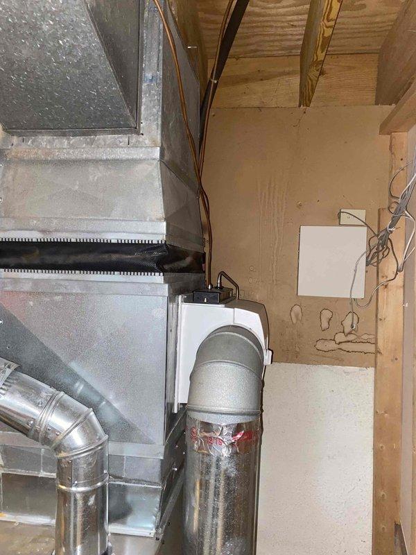 Completed comprehensive tune-up on residential furnace system located in basement. Unit is approximately 3-4 years old and appears to be in serviceable condition. Performed standard maintenance protocol including inspection of heat exchanger, burner assembly, and ignition components. Verified proper operation of blower motor and checked electrical connections. Inspected condensate drain lines and PVC piping for proper drainage. Evaluated ductwork connections and assessed overall system airflow. Documented equipment condition with photographic records showing HVAC unit installation area, ductwork configuration, and surrounding mechanical space. System operating within normal parameters following maintenance service. Provided estimates for additional equipment including air conditioning system and chimney cap installation as requested.