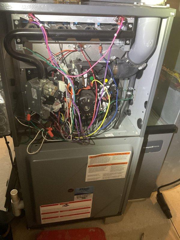 Completed comprehensive Gold Furnace Inspection on a 6-year-old forced air unit located in basement. Performed full system evaluation including visual inspection of all internal components with front access panel removed. Inspected gas valve assembly, burner tubes, heat exchanger, blower motor assembly, and electrical connections throughout the system. Examined and tested flame sensor, verifying proper operation and cleaning as needed. Checked all wire connections including multi-colored wiring harnesses and wire nuts for secure termination. Evaluated burner operation, gas pressure, and combustion efficiency. Inspected flexible connecting tubing and all mechanical linkages. Verified proper airflow through blower assembly. Confirmed all safety labels and manufacturer specifications are visible and intact. Unit operational and functioning within normal parameters at time of inspection. Documented system condition with photographs for maintenance records.