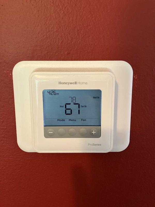Completed full HVAC system installation including 70,000 BTU furnace, hot water heater, and humidifier with all necessary mechanical, electrical, and plumbing permits. Installed Honeywell ProSeries digital thermostat for system control and reconnected electrical service at exterior meter with disconnect switch. System tested and operational, with utility rebate documentation submitted.