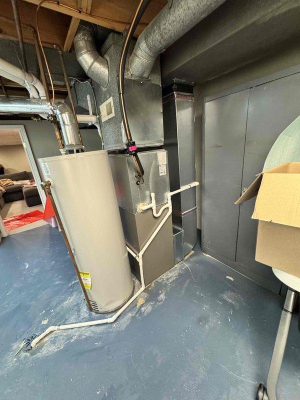Completed installation of 70,000 BTU residential furnace replacement in basement utility room, including integration of ecobee 3 lite thermostat and humidifier system. All ductwork connections were properly secured to the new furnace unit, with copper and PVC piping routed appropriately for optimal system performance. Permit was requested and utility rebate paperwork was processed for both Consumers Energy and DTE programs.