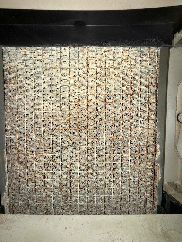 Responded to no heat call on 15-year-old furnace located in basement with reported rattling noise. Upon inspection, found severely clogged air filter with extensive dirt and debris accumulation restricting airflow and causing system malfunction. Replaced heavily soiled filter with new unit, restoring proper airflow and eliminating rattling noise. System tested and confirmed operational with heat output restored to normal levels.