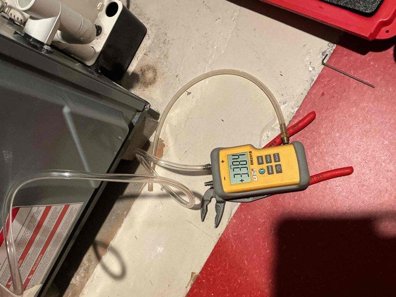 Completed comprehensive Gold-level preventative maintenance and winter readiness inspection on a 6-year-old Daikin DM96SE0603BNAA high-efficiency furnace as part of membership plan coverage. Performed full system diagnostics including electrical testing with multimeter to verify proper voltage and amperage at all connections, confirmed ignition sequence operation, and measured supply air temperature at 196°F indicating proper heat exchanger performance. Inspected all accessible components including burner assembly, flame sensor, pressure switches, and condensate drainage system with visible trap assembly. Evaluated furnace installation environment in basement location, noting moisture conditions on concrete floor surface that warrant monitoring to prevent potential corrosion or component degradation over time. All safety controls tested and verified operational, system cycling properly with no immediate concerns identified. Unit is operating within manufacturer specifications and prepa