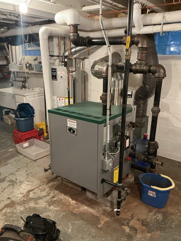 Completed comprehensive Gold furnace inspection on two HVAC units located in basement mechanical room. Both units are approximately 3 years old and operating properly at time of service. Performed full system evaluation including visual inspection of boiler/heating unit with expansion tank, examined all piping connections and insulation integrity, verified proper operation of control panels and safety systems, and inspected water heater and associated plumbing components. All equipment found to be in good working condition with no immediate service needs identified. Documentation photos captured for maintenance records.
