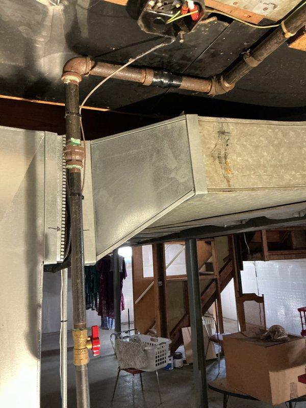 Responded to gas pipe leak identified by utility company during furnace installation. Conducted comprehensive inspection of basement piping system, including gas lines, copper water supply lines, and connections near HVAC equipment and water heater. Utility company had tagged leaking pipes requiring replacement and issued temporary fix, though permanent pipe replacement still necessary for code compliance. Assessed condition of galvanized steel gas piping showing oxidation and wear, evaluated copper pipe connections displaying patina and corrosion at fittings, and examined all joints and valves in the mechanical room. Documented existing conditions with photographs showing vertical pipe runs, elbow fittings, and connections to heating system and water heater. Provided detailed estimate for complete gas pipe replacement to address utility company findings and ensure safe operation of all gas-fired appliances. Previous furnace installation had passed city inspection, but subsequent utili