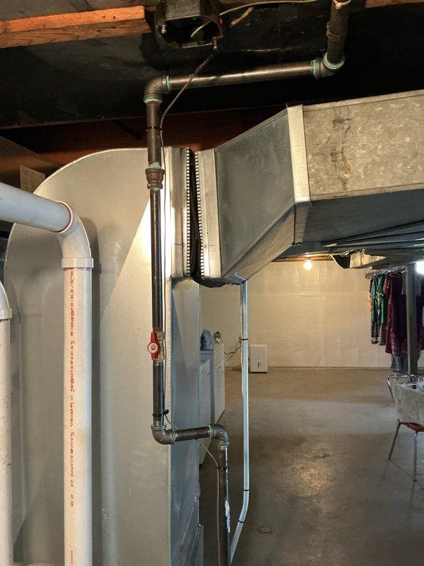 Responded to gas pipe leak identified by utility company during furnace installation. Conducted comprehensive inspection of basement piping system, including gas lines, copper water supply lines, and connections near HVAC equipment and water heater. Utility company had tagged leaking pipes requiring replacement and issued temporary fix, though permanent pipe replacement still necessary for code compliance. Assessed condition of galvanized steel gas piping showing oxidation and wear, evaluated copper pipe connections displaying patina and corrosion at fittings, and examined all joints and valves in the mechanical room. Documented existing conditions with photographs showing vertical pipe runs, elbow fittings, and connections to heating system and water heater. Provided detailed estimate for complete gas pipe replacement to address utility company findings and ensure safe operation of all gas-fired appliances. Previous furnace installation had passed city inspection, but subsequent utili