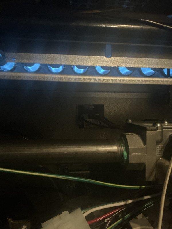 Completed comprehensive furnace inspection and tune-up on forced air heating system located in basement. Verified proper ignition and burner operation with all burners firing evenly with consistent blue flame pattern. Confirmed thermostat functionality and system controls operating correctly in heating mode.