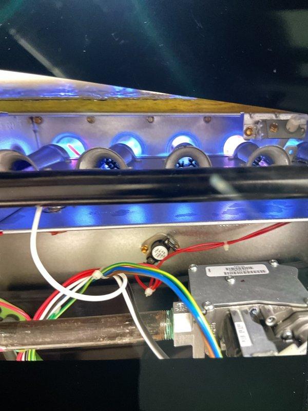 Responded to no heat call on 10+ year old forced air furnace located in basement. Upon inspection, found burners were not igniting properly due to failed flame sensor. Removed flame sensor using hex key tool, cleaned carbon buildup from sensor rod, and reinstalled component. Verified proper ignition sequence, confirmed all burners lit with strong blue flames, and tested system operation through complete heating cycle. Unit restored to normal operation with adequate heat output.