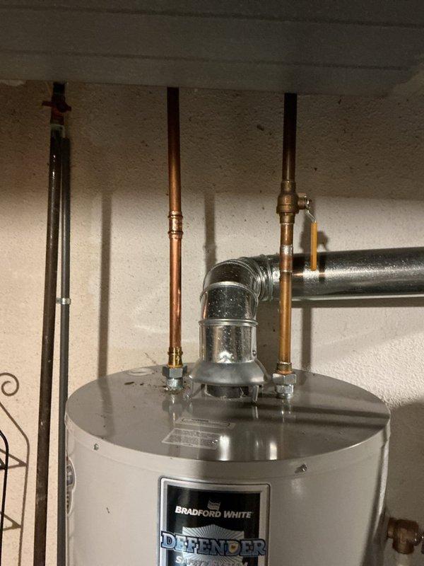 Replaced existing water heater due to significant corrosion around the dielectric fittings. Installed a 50-gallon Bradford White Defender Safety System standard tank water heater. Connected all copper supply lines and venting system to ensure proper operation and code compliance.