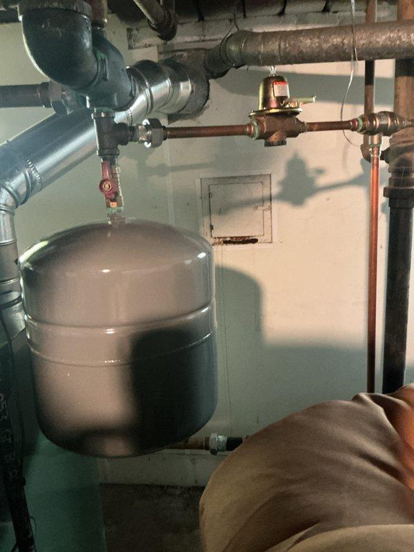 Completed comprehensive inspection and tune-up of steam boiler system installed in November 2022, located in basement. Inspected expansion tank, pressure gauge readings, copper piping connections, control valves, and associated ductwork for proper operation and safety compliance. All components found to be functioning within normal parameters with no immediate repairs required.