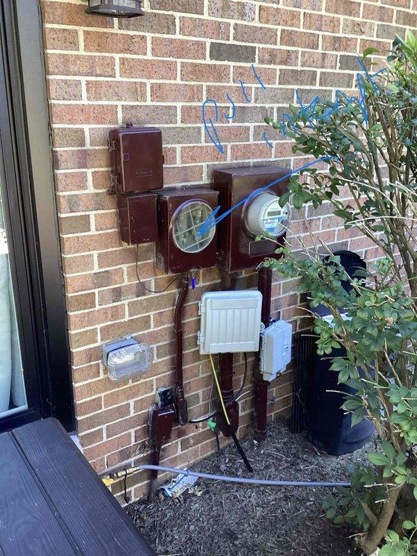Completed electrical estimate for generator installation at residential property with existing exterior electrical service panel mounted on brick wall. Assessed current utility meter configuration, main service disconnect, and electrical panel arrangement to determine feasibility and requirements for generator integration. Evaluated electrical service capacity and existing conduit routing for proper generator connection and automatic transfer switch placement.

Provided comprehensive quote for hot water heater replacement, as existing unit has reached end of service life. Inspected current water heater installation including supply and drainage plumbing connections, shutoff valves, temperature and pressure relief valve discharge piping, and venting configuration. Documented existing plumbing layout featuring combination of copper, PVC, and flexible supply lines with multiple shutoff points. Assessed electrical or gas connections, clearance requirements, and code compliance consideratio