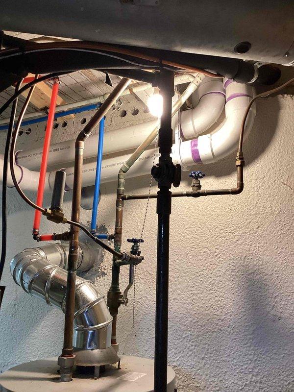 Completed electrical estimate for generator installation at residential property with existing exterior electrical service panel mounted on brick wall. Assessed current utility meter configuration, main service disconnect, and electrical panel arrangement to determine feasibility and requirements for generator integration. Evaluated electrical service capacity and existing conduit routing for proper generator connection and automatic transfer switch placement.

Provided comprehensive quote for hot water heater replacement, as existing unit has reached end of service life. Inspected current water heater installation including supply and drainage plumbing connections, shutoff valves, temperature and pressure relief valve discharge piping, and venting configuration. Documented existing plumbing layout featuring combination of copper, PVC, and flexible supply lines with multiple shutoff points. Assessed electrical or gas connections, clearance requirements, and code compliance consideratio