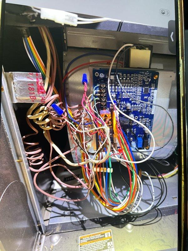 Responded to no-heat call on 5-year-old Bryant 80% efficiency gas furnace located in basement. Upon arrival, confirmed unit was not responding to thermostat call for heat. Removed and inspected furnace control panel, revealing complex wiring assembly and integrated control board. Performed diagnostic evaluation of control board (HKA2FZZ0864920 V02), examining surface-mount components, integrated circuits, capacitors, and resistors for signs of failure. Inspected all wire connections, terminals, and safety circuits within the control compartment. Documented control board condition and wiring configuration with photographs for service records. Diagnostic testing completed to identify root cause of no-heat condition.