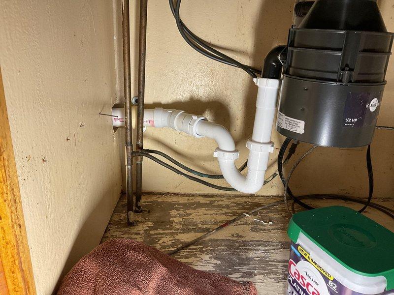 Replaced kitchen drain stack and branch lines with new PVC piping system. Installed vertical drain stack from basement through kitchen, including proper venting and trap configuration for sink and garbage disposal connection. All connections tested and verified leak-free upon completion.