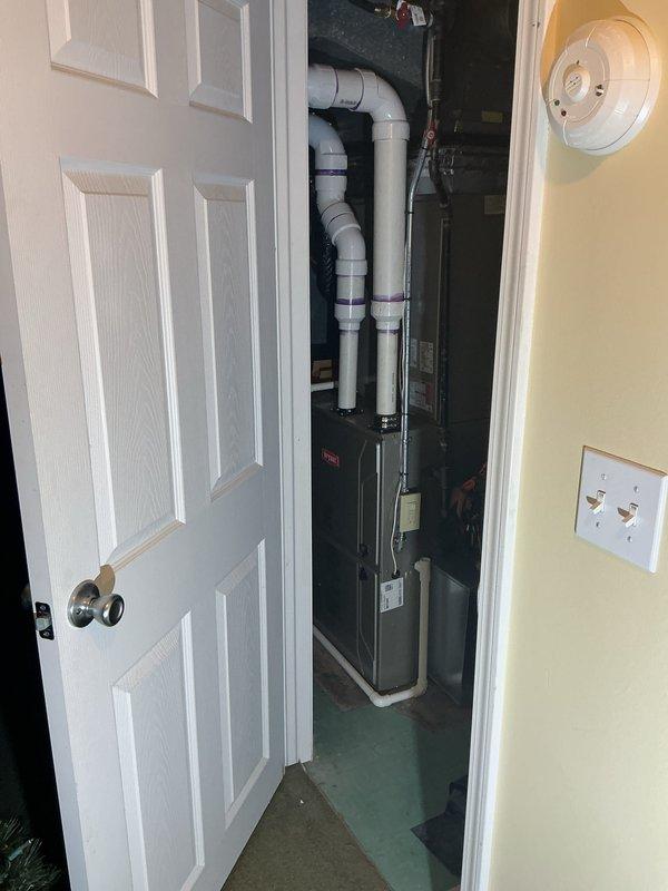 Completed pre-winter tune-up on 6-year-old furnace system located in basement mechanical room. Performed comprehensive inspection of all system components, verified proper operation of burners and heat exchanger, checked and cleaned blower assembly, tested safety controls and limit switches, inspected condensate drain lines and PVC venting system, and confirmed thermostat functionality showing proper temperature control at 69 degrees. All components operating within manufacturer specifications with no issues identified.