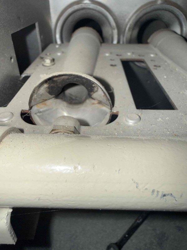 Completed Gold Furnace Inspection on a 30+ year old forced air heating system located in basement. Performed comprehensive multi-point inspection of furnace components, including heat exchanger, burner assembly, blower motor, and all safety controls. Inspected gas connections and flue pipe assembly, noting visible corrosion and rust staining around circular port connection on horizontal vent piping and mounting bracket. Verified proper operation of all system components and confirmed unit is functioning as designed. Documented equipment condition with photos showing age-related wear on mechanical components and venting system. System operational at time of inspection with no immediate safety concerns requiring shutdown.