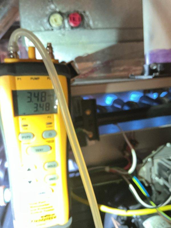 Completed comprehensive Gold Furnace Inspection on 10+ year old forced air unit located in basement. Performed diagnostic testing using digital manometer to verify gas pressure readings at 1.50 and 1.3 inches water column, and measured temperature differential readings of 34.8°F and 34.9°F across heat exchanger. Inspected control board with illuminated LED indicators confirming proper operation, examined electrical connections and wiring throughout system, and verified all safety controls functioning correctly. Unit operating within manufacturer specifications with no immediate repairs required at time of inspection.