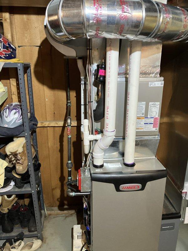 Completed installation of 70,000 BTU Lennox furnace system in basement utility area, including new thermostat and humidifier replacement. Installed PVC venting, connected electrical service at breaker panel, and routed all necessary ductwork and condensate drainage. Mechanical and electrical permits obtained and all work completed to code specifications.