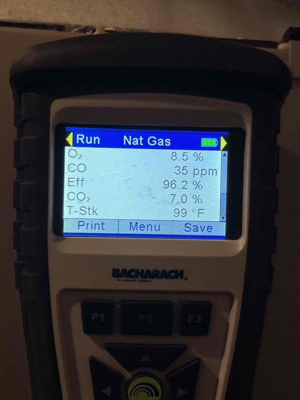 Responded to no heat call on 13-year-old Bryant 925SA42060E17A-A furnace. Upon arrival, confirmed thermostat display was functioning after battery replacement but furnace remained inoperative. Performed diagnostic testing on furnace system including electrical measurements with multimeter on blower motor circuits and wiring connections. Conducted combustion analysis using Bacharach analyzer, which showed acceptable readings: O₂ at 8.5%, CO at 35 ppm, efficiency at 96.2%, CO₂ at 7.0%, and stack temperature at 99°F. Traced issue to failed communication between Model 3002 thermostat and furnace control board. Verified all wire connections at thermostat and furnace terminal strip, finding intermittent connection on R-wire terminal causing loss of 24V signal to gas valve circuit. Cleaned and re-seated thermostat wiring connections, tested blower motor amperage and capacitor values within manufacturer specifications. Cycled system through multiple heating cycles to verify proper ignition seq